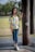 A woman standing next to a tree in a park