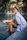 A woman sitting on the edge of a swimming pool