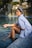 A woman sitting on the edge of a swimming pool