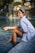 A woman sitting on the edge of a swimming pool