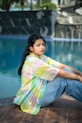 A woman sitting on the edge of a swimming pool