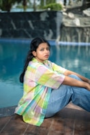 A woman sitting on the edge of a swimming pool