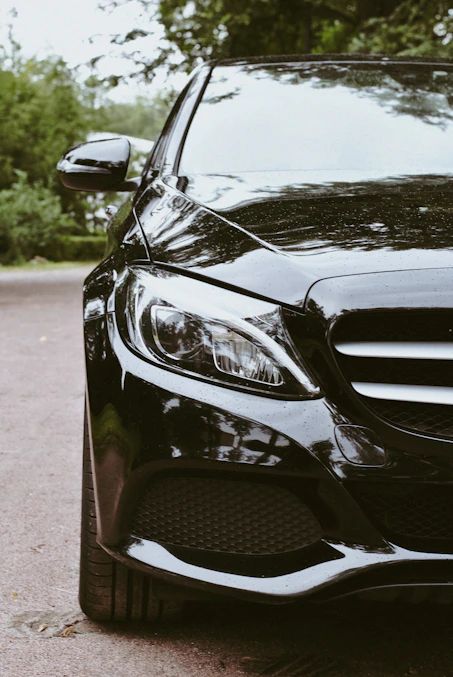 A black car parked on the side of the road