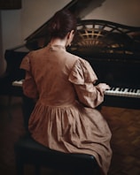 A woman sitting at a piano in a room