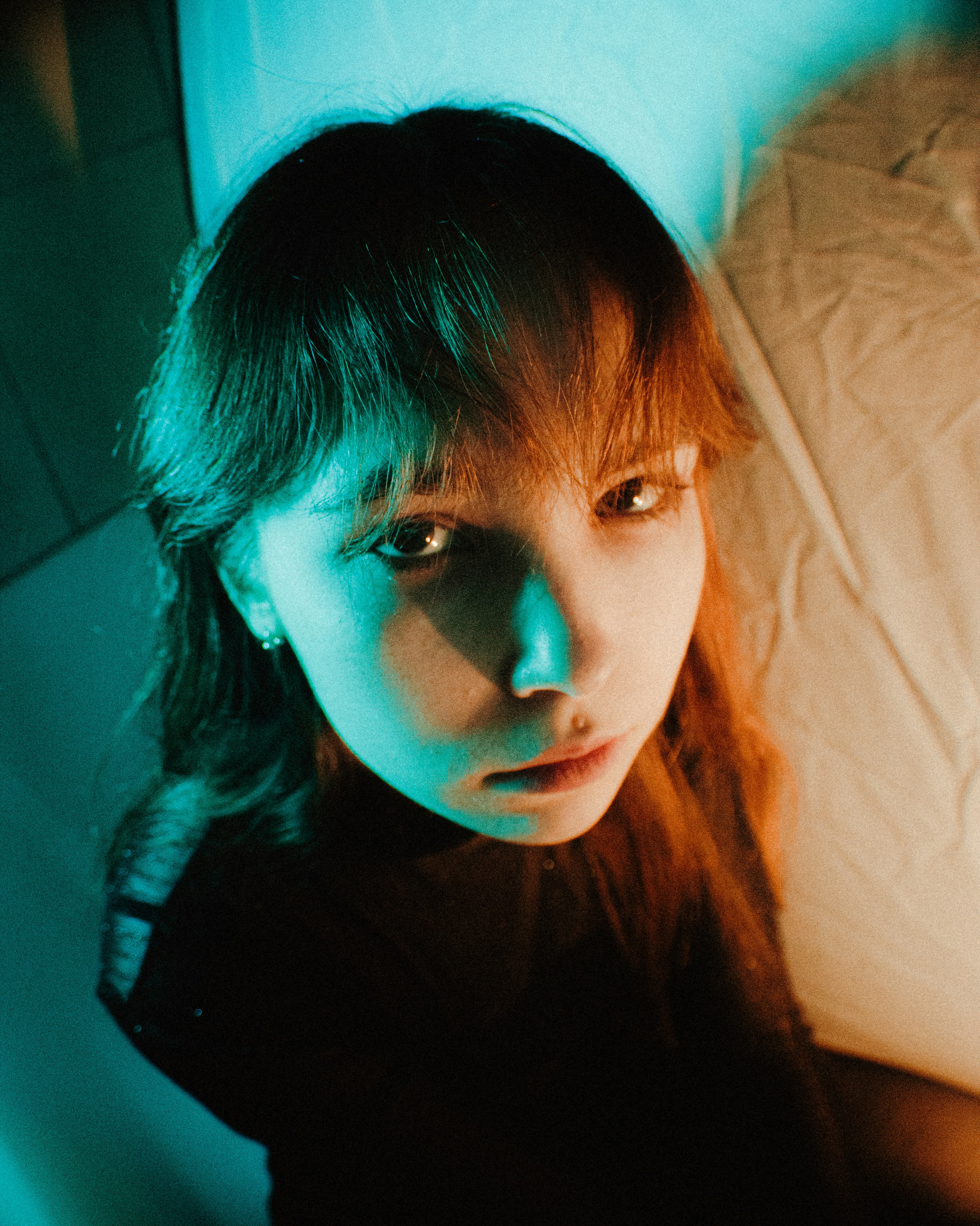 A woman with long hair is looking at the camera