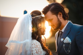 A bride and groom standing next to each other