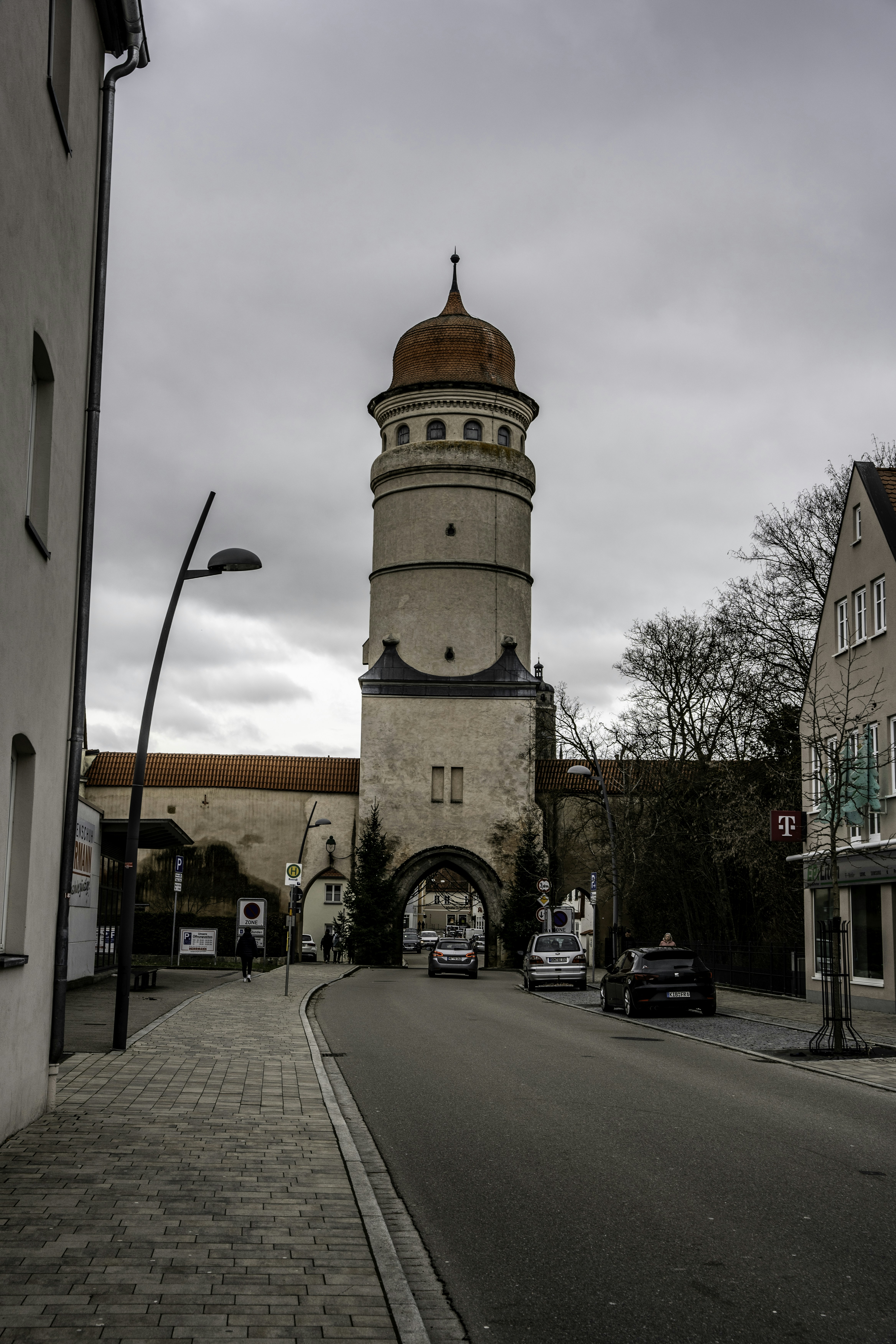 A tall clock tower towering over a city street