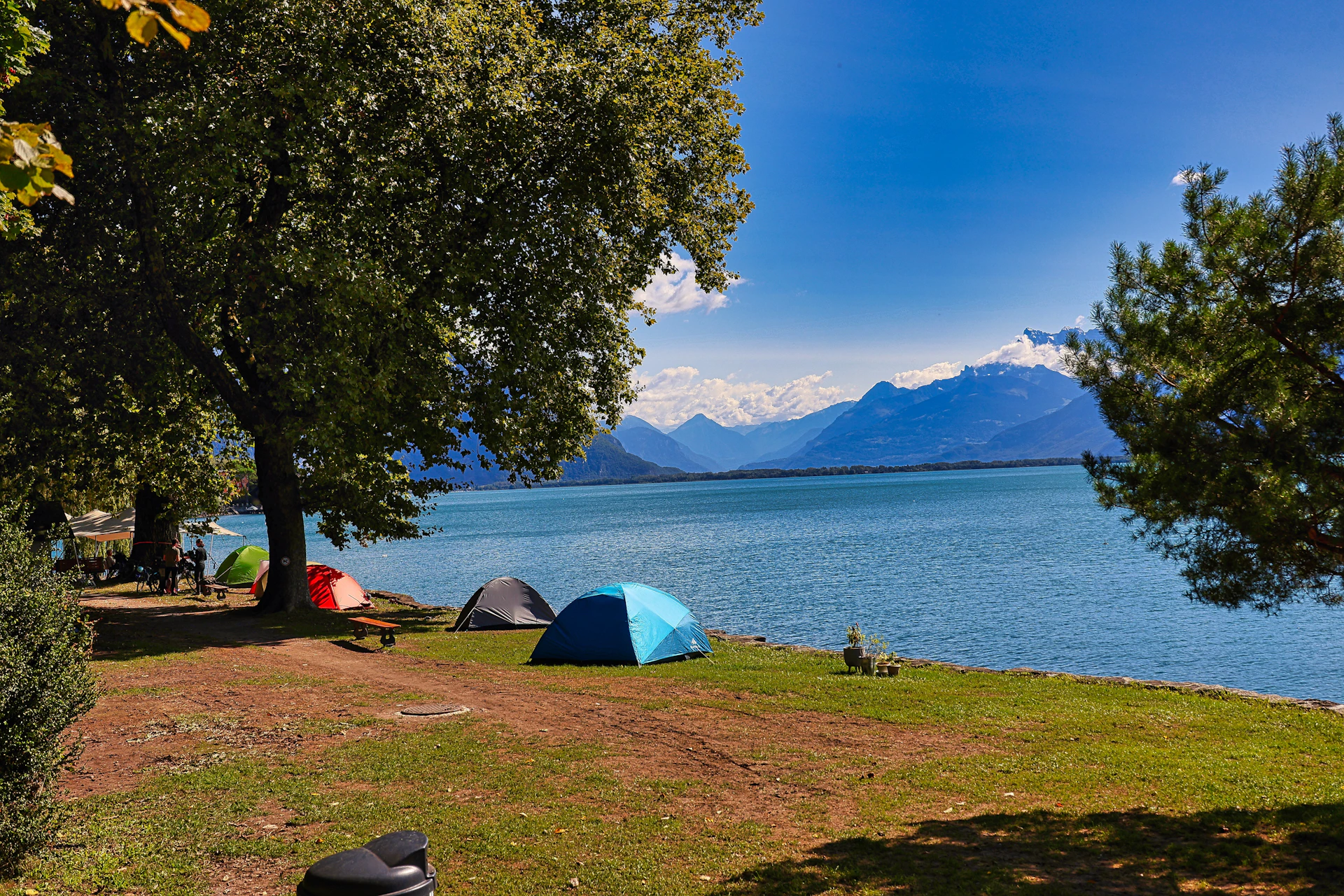 A group of tents sitting next to a body of water