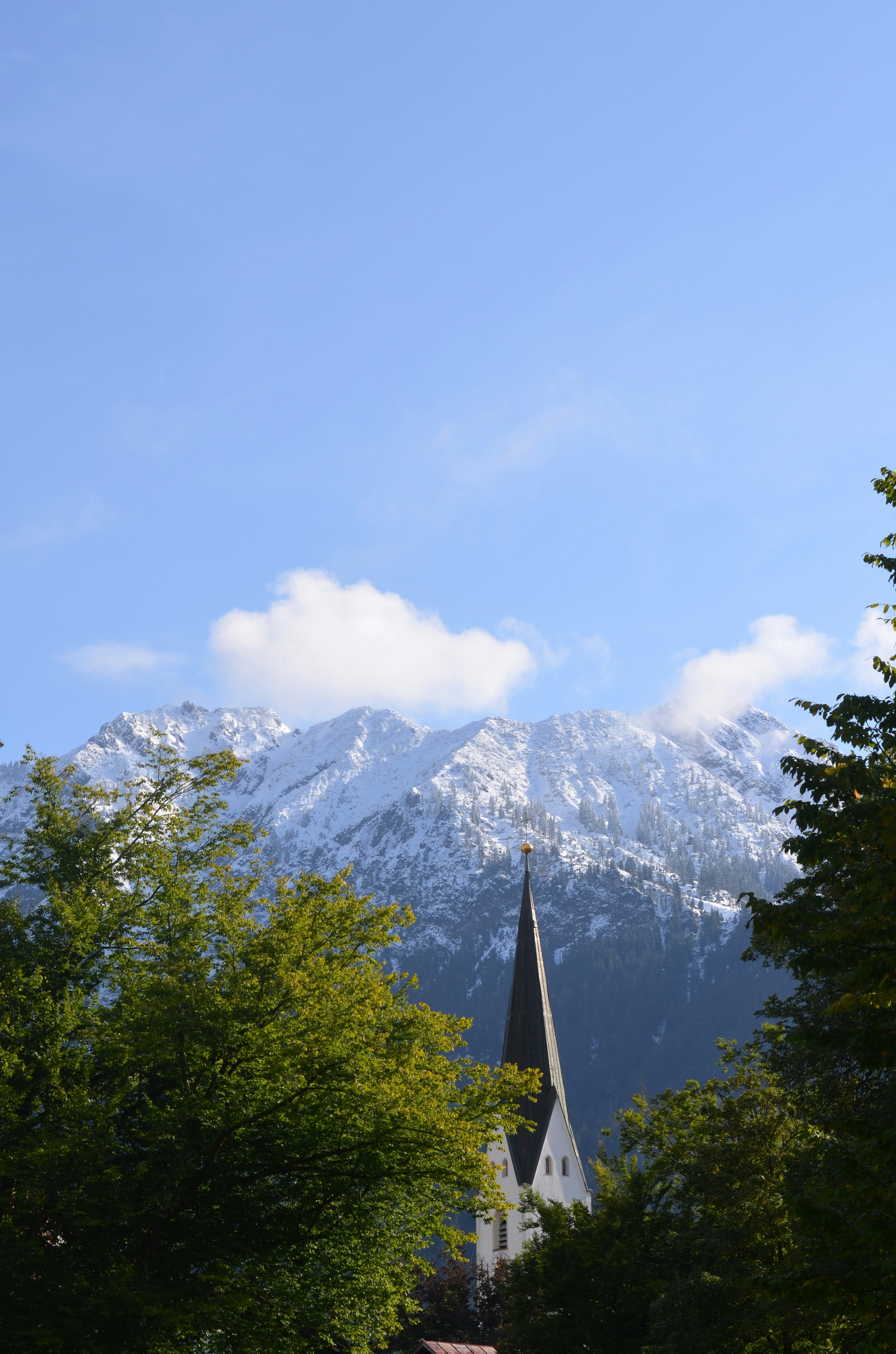 A church steeple with a snowy mountain in the background photo – Free ...