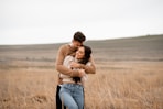 A man and a woman hugging in a field