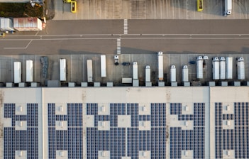 An aerial view of a parking lot with cars