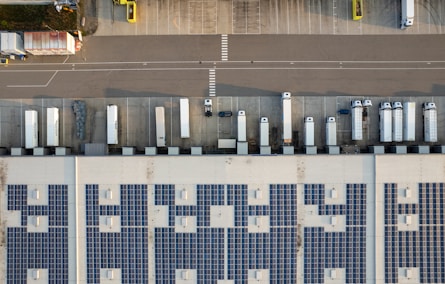 An aerial view of a parking lot with cars