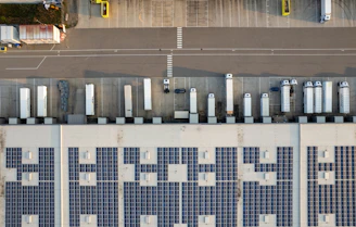 An aerial view of a parking lot with cars