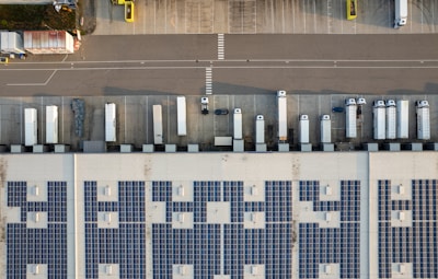 An aerial view of a parking lot with cars