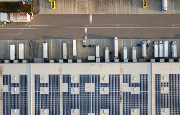 An aerial view of a parking lot with cars