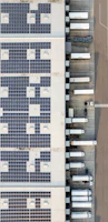 An aerial view of a building with a lot of solar panels
