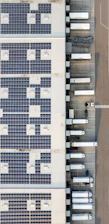 An aerial view of a building with a lot of solar panels