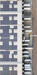 An aerial view of a building with a lot of solar panels