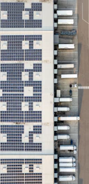 An aerial view of a building with a lot of solar panels