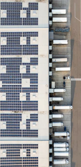 An aerial view of a building with a lot of solar panels
