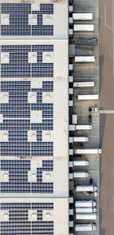 An aerial view of a building with a lot of solar panels