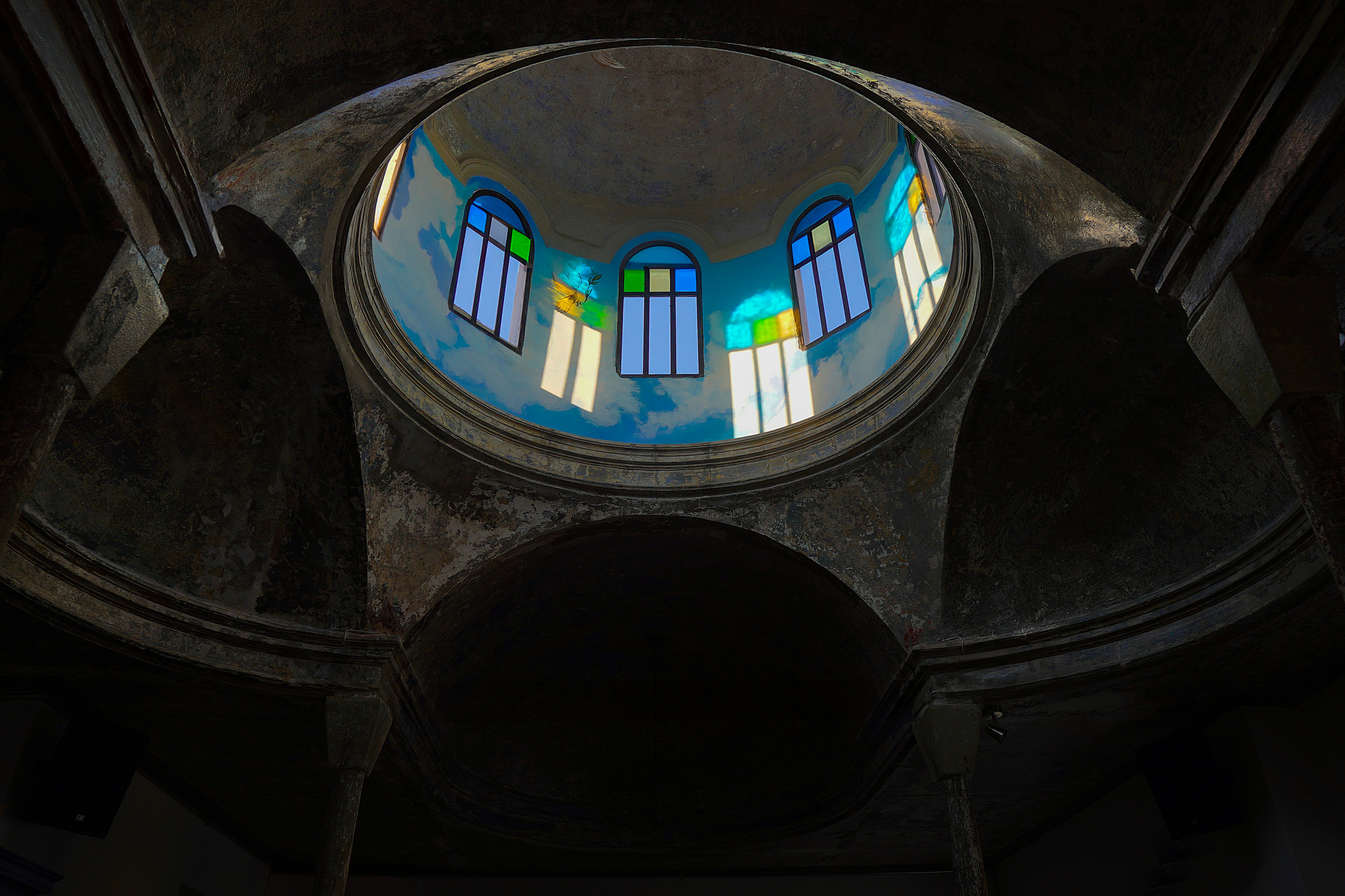 The inside of a church with a stained glass window