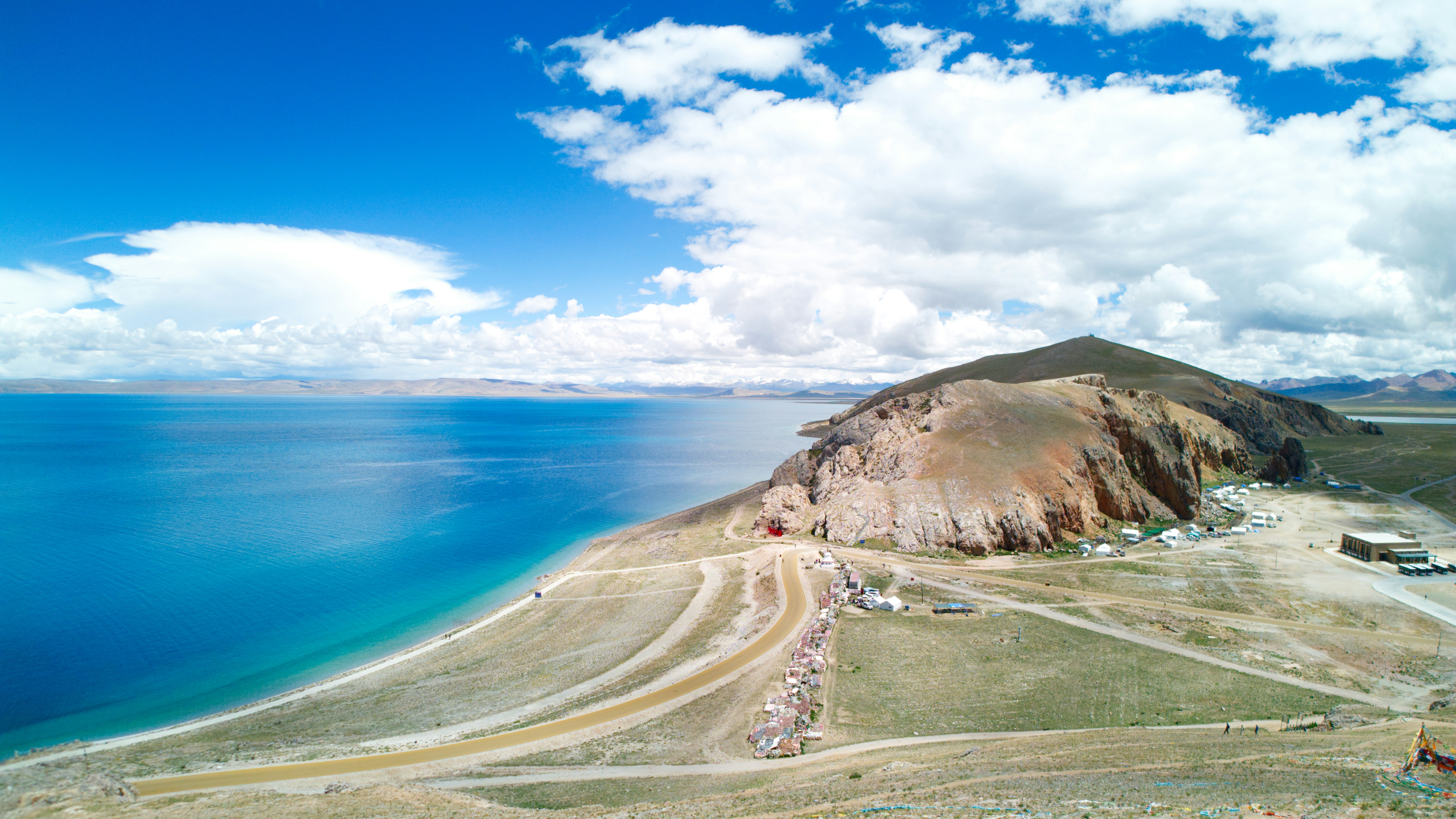 A large body of water with a mountain in the background
