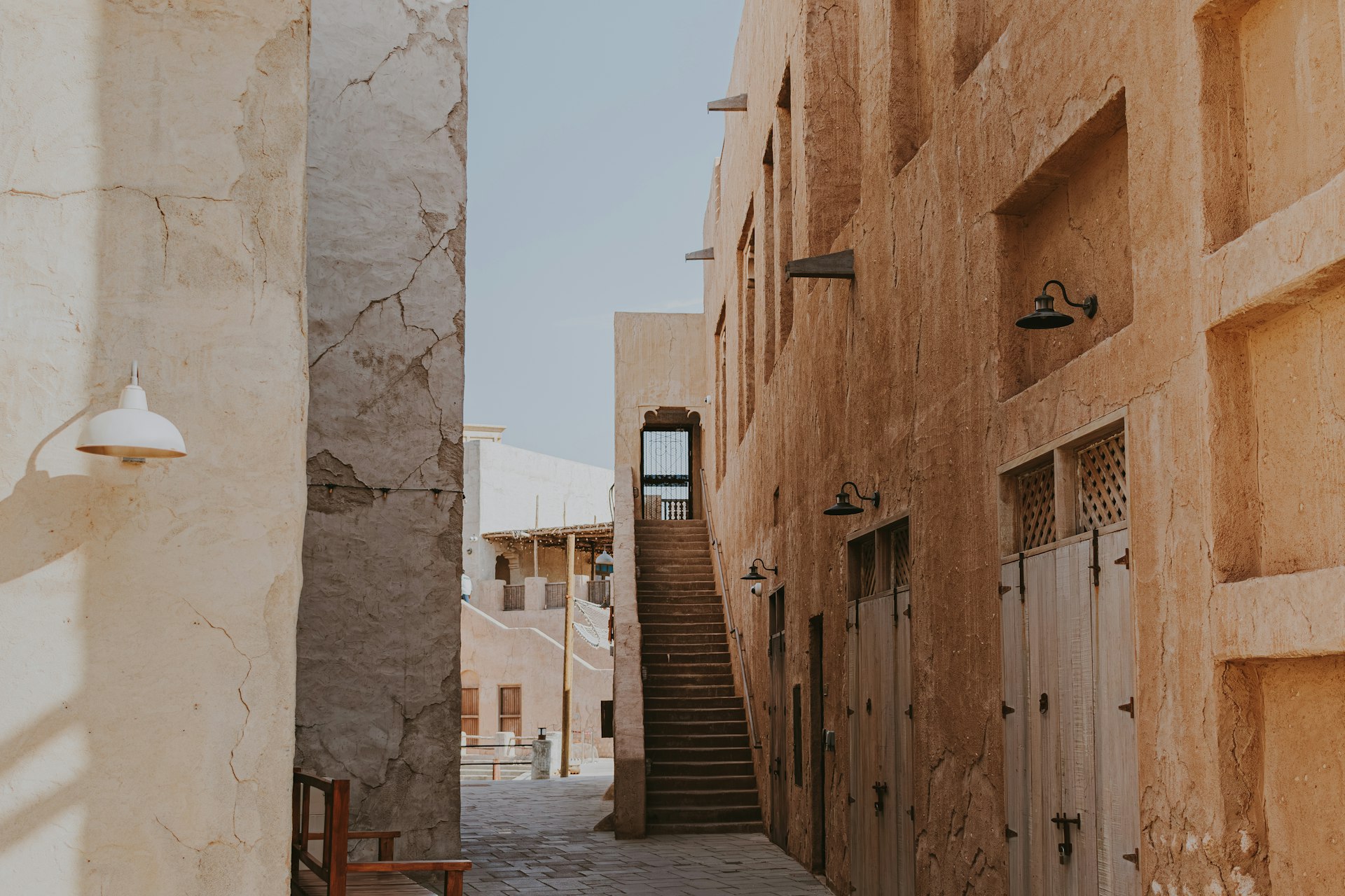 A narrow alley way with steps leading up to a building