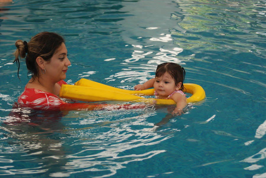 Instructor supporting child in pool