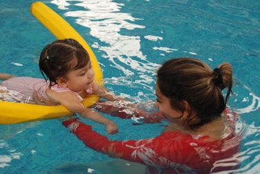 A woman and a child in a swimming pool