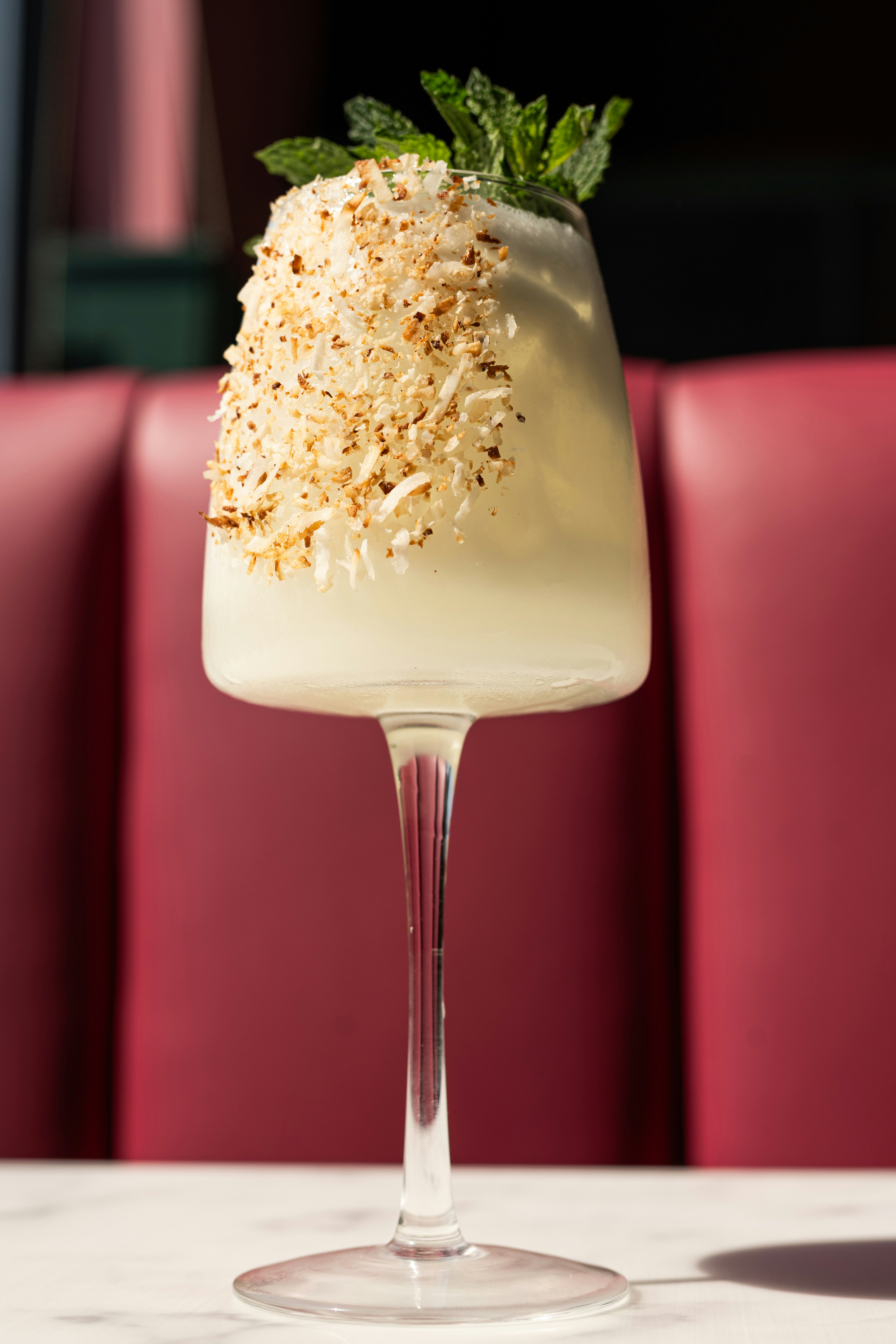 A dessert in a wine glass on a table