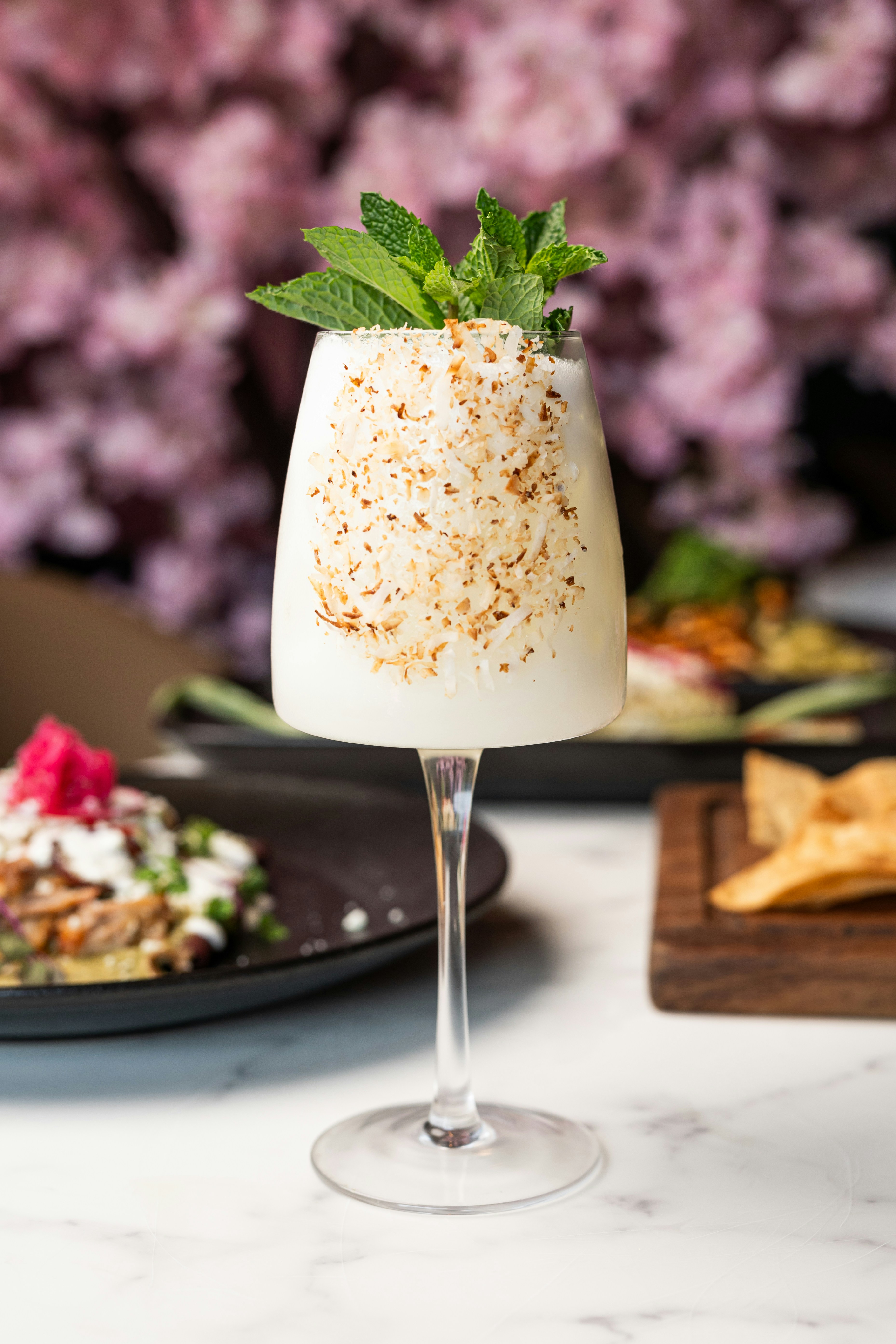 A table topped with plates of food and drinks