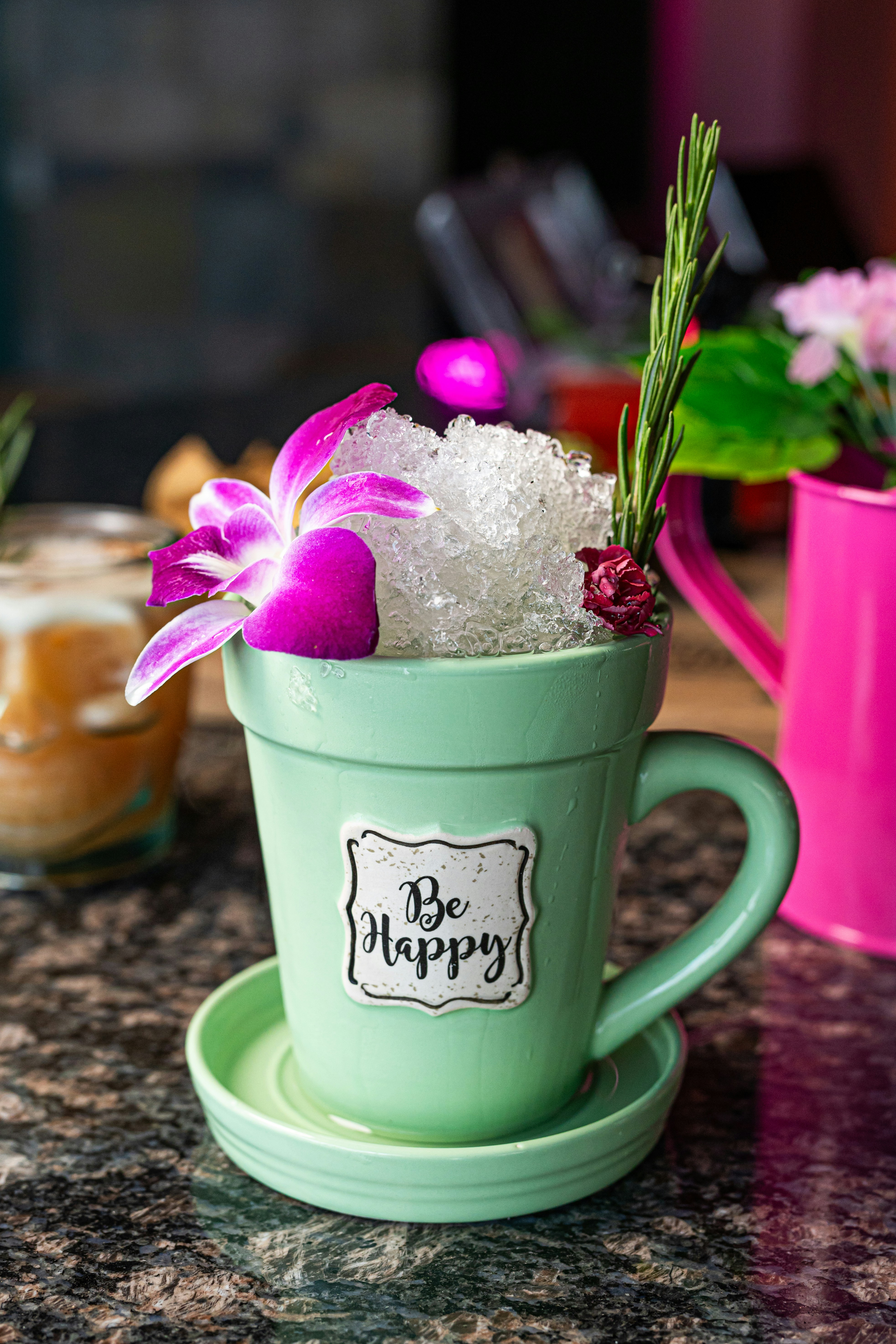 A cup filled with ice and flowers on top of a table