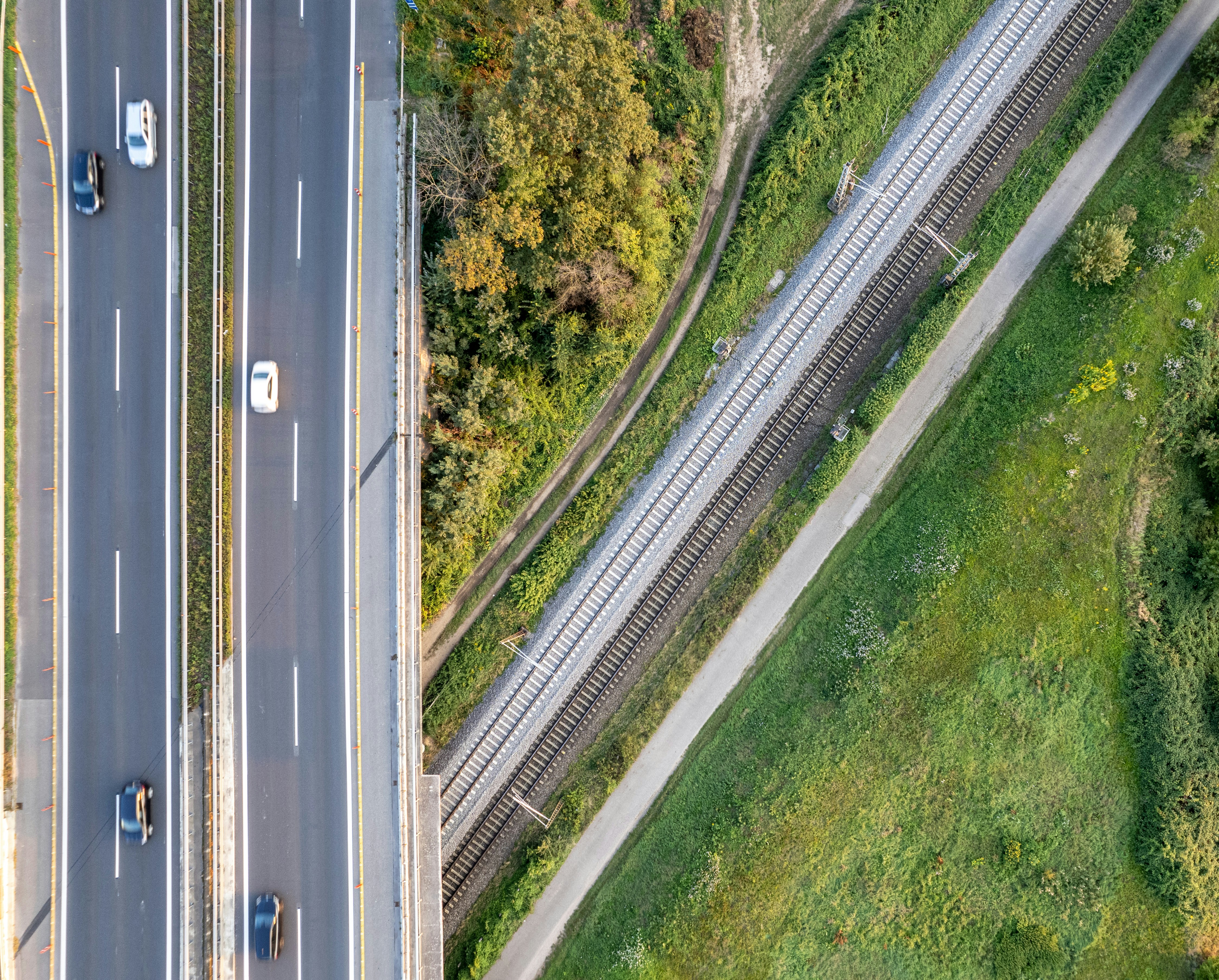 An aerial view of a highway in the middle of a forest