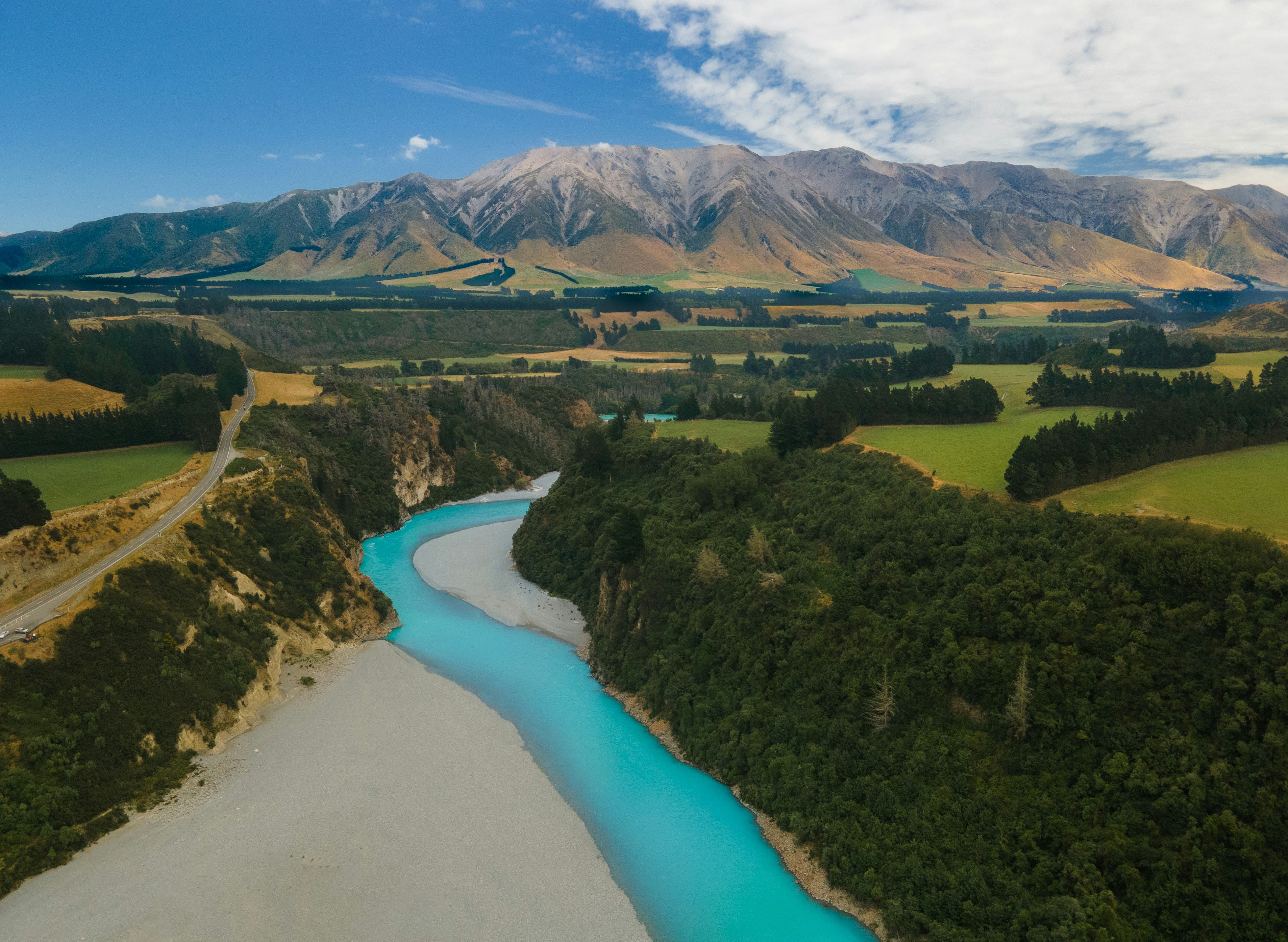 A river running through a lush green valley