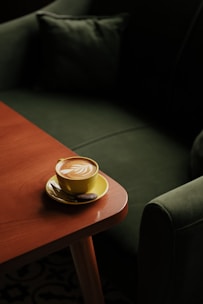 A cup of coffee sitting on top of a wooden table