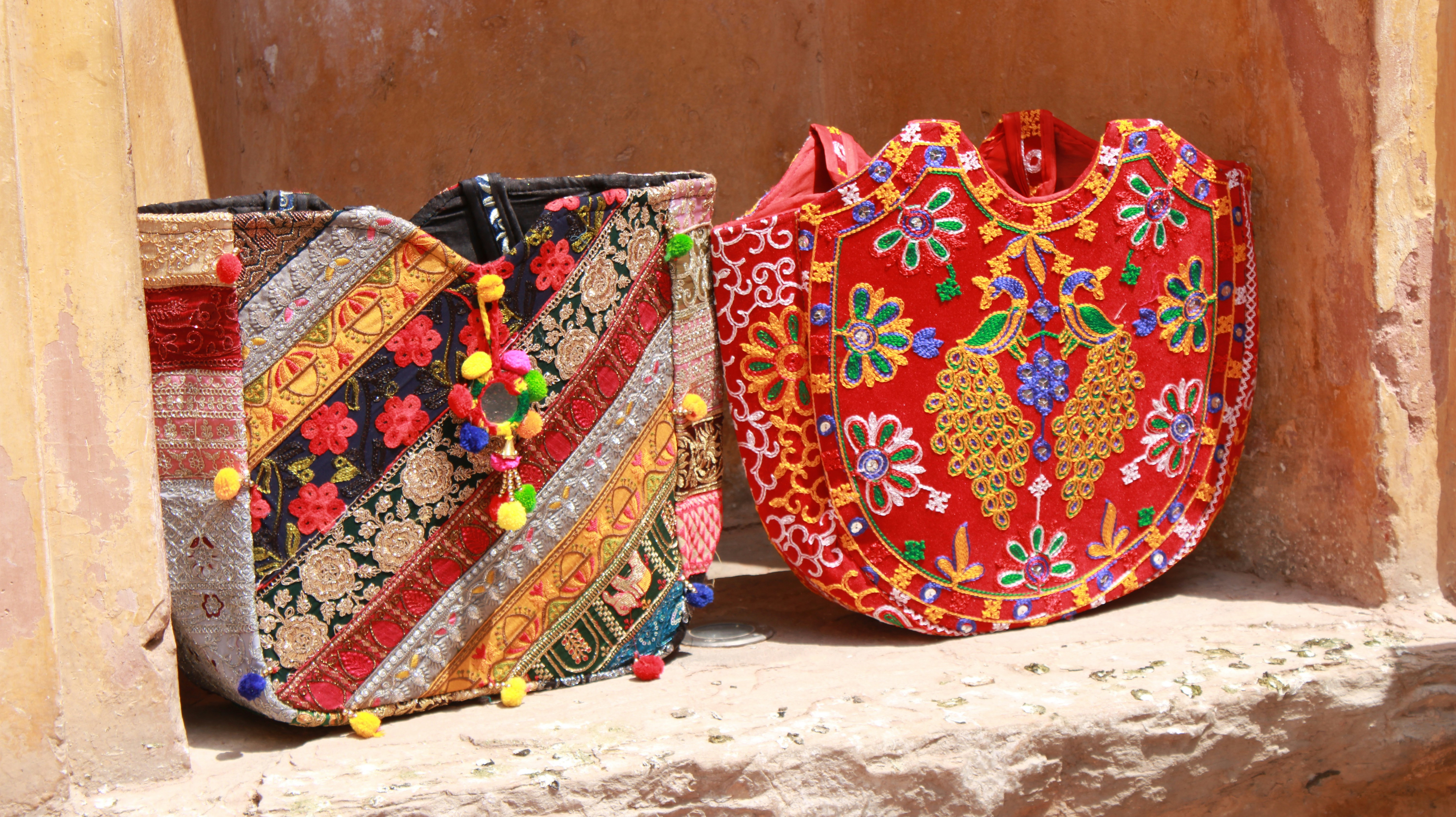 A couple of bags sitting on top of a window sill