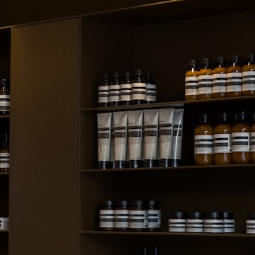 A shelf filled with lots of bottles of liquid