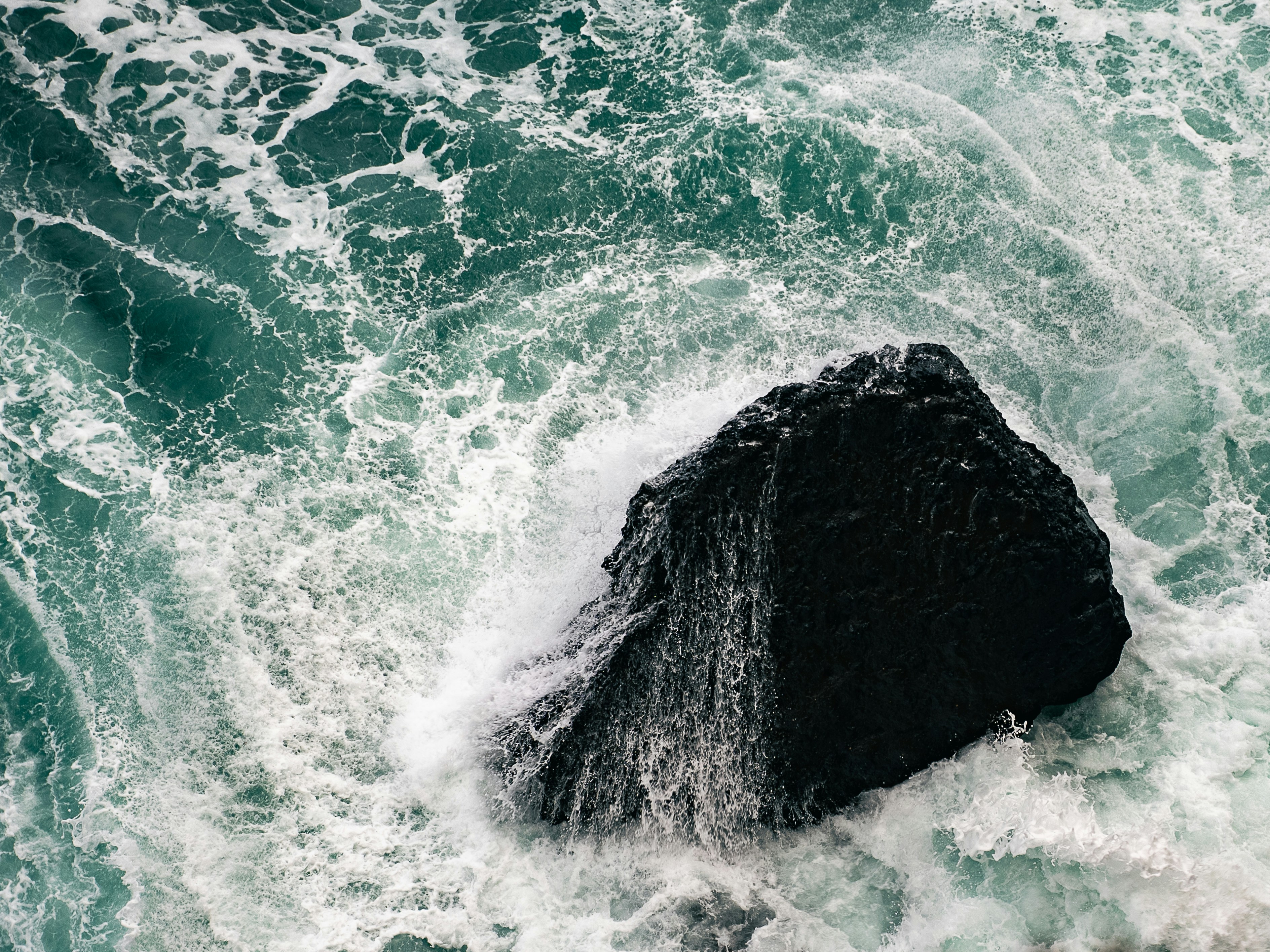 A large rock in the middle of the ocean