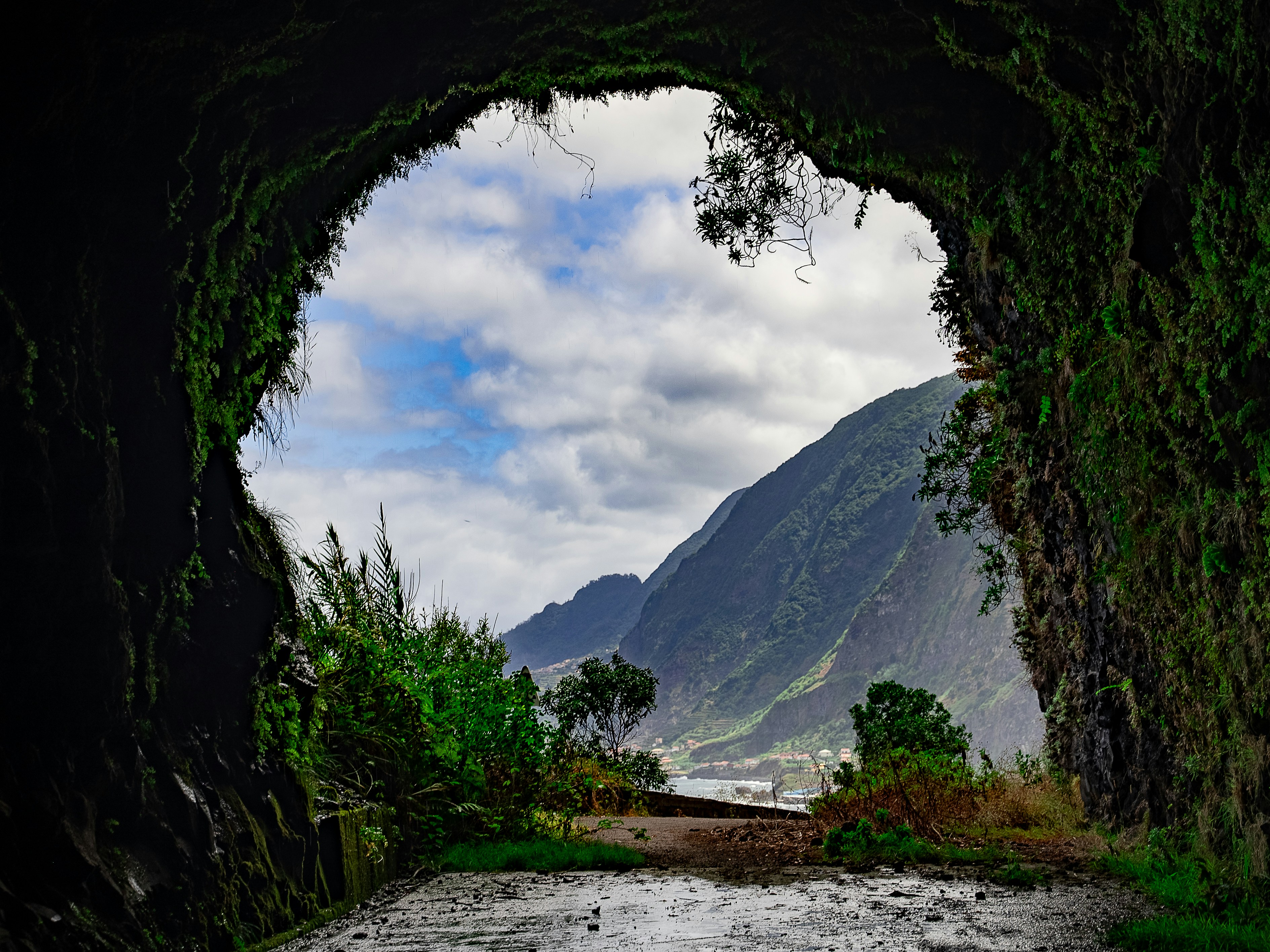 A view of a mountain through a tunnel