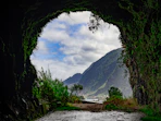 A view of a mountain through a tunnel