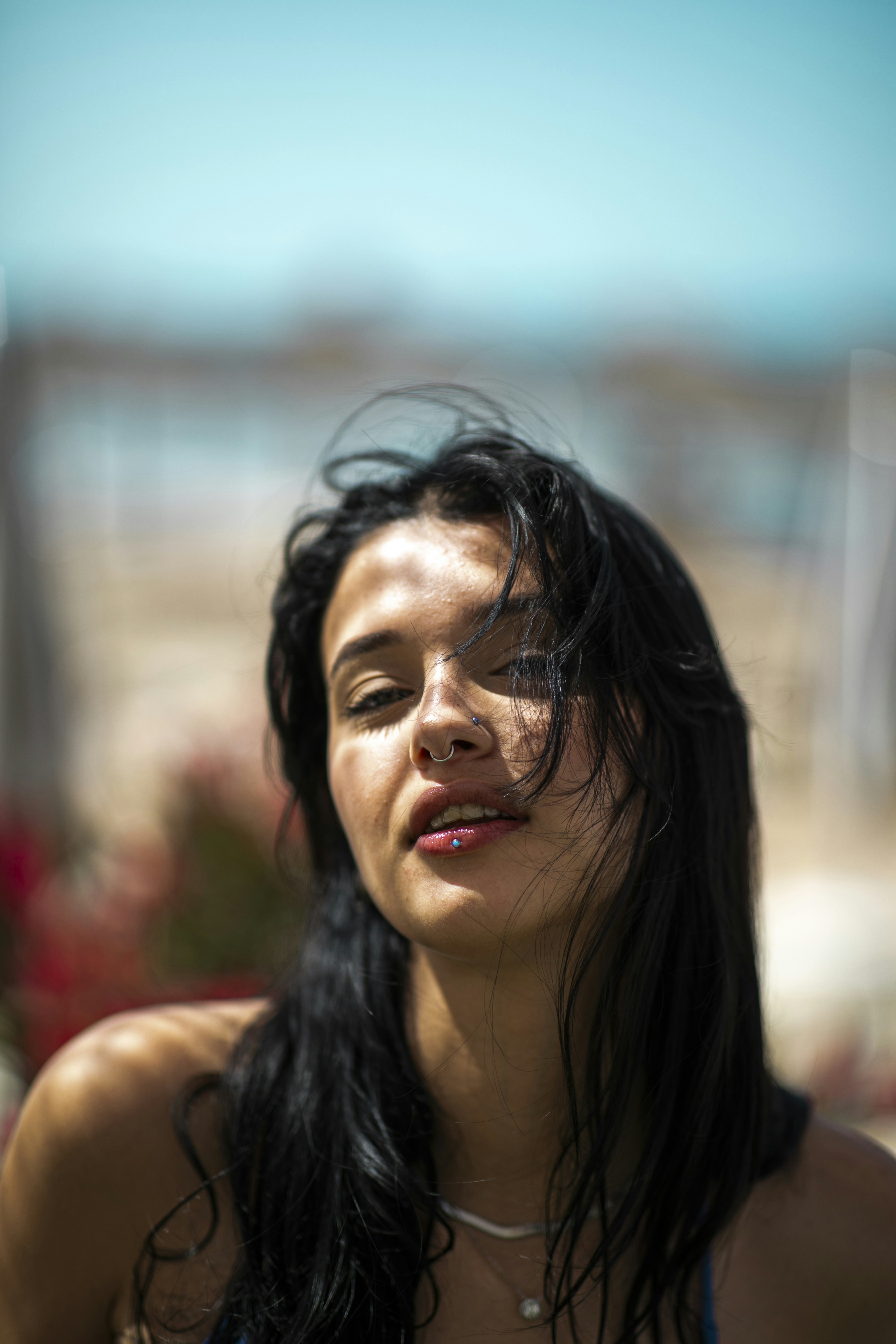 A woman with long black hair holding a cell phone