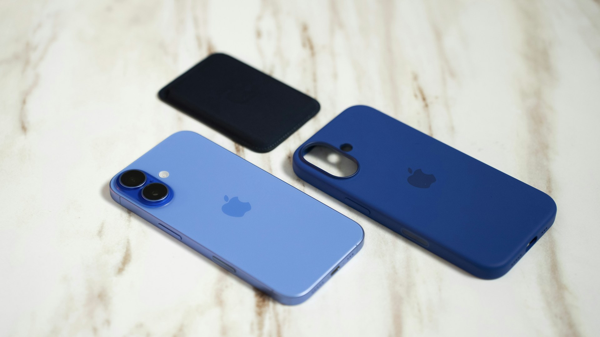 Three iphones sitting next to each other on a table