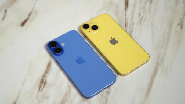 Two iphones sitting next to each other on a table