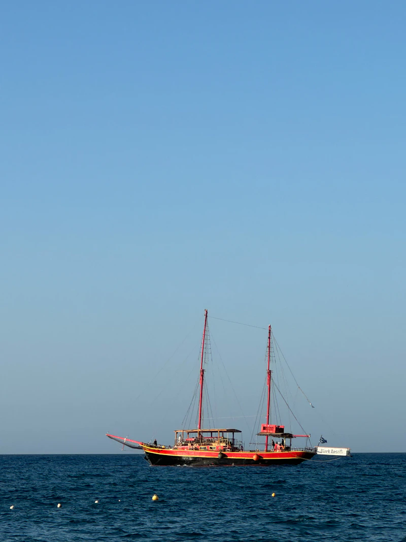 Red vessel floating on open water