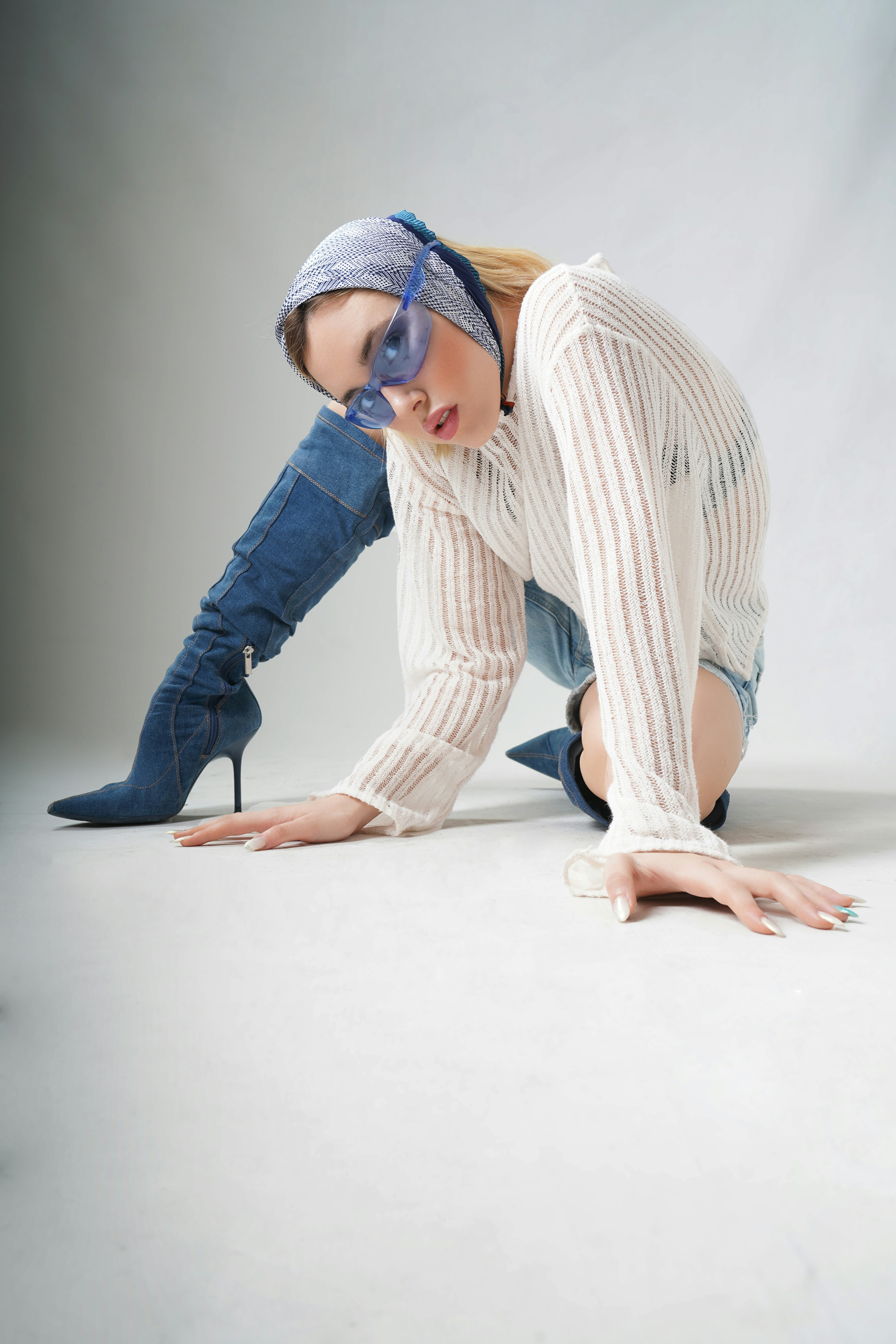 A woman in a white shirt and blue jeans