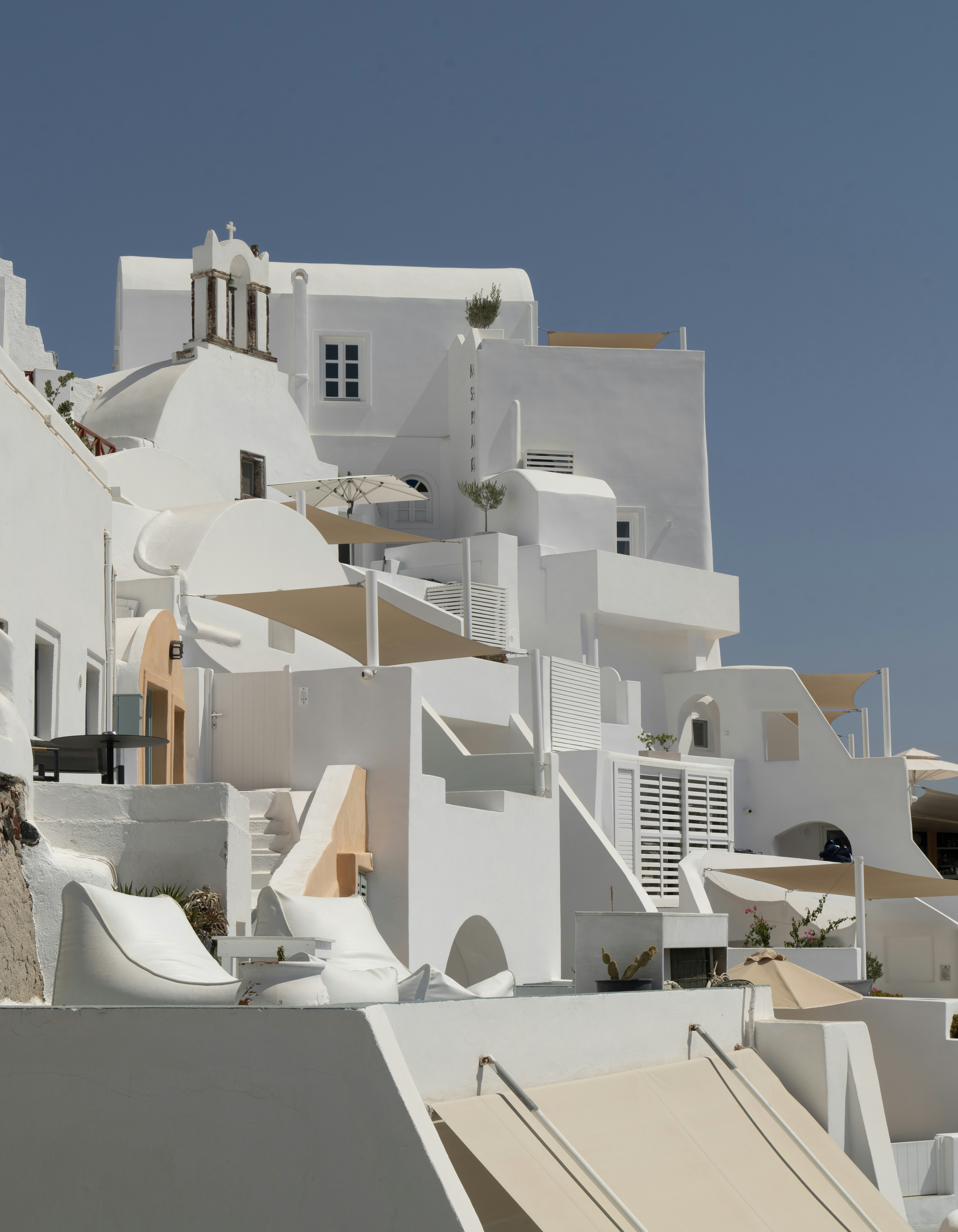 A white building with a lot of balconies on top of it