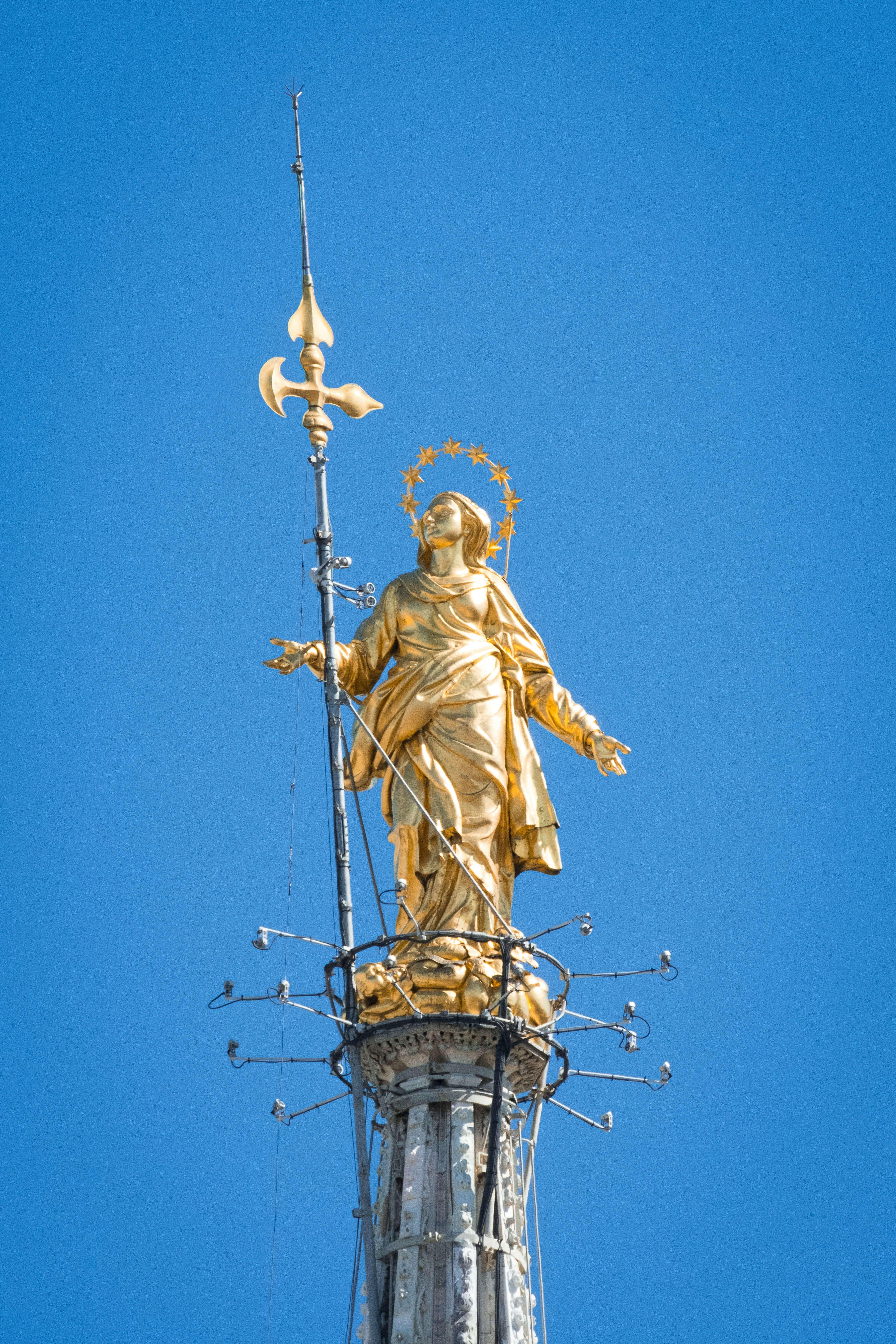 A golden statue on top of a tall building
