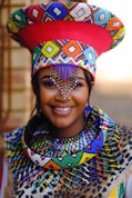 A woman wearing a colorful hat and scarf