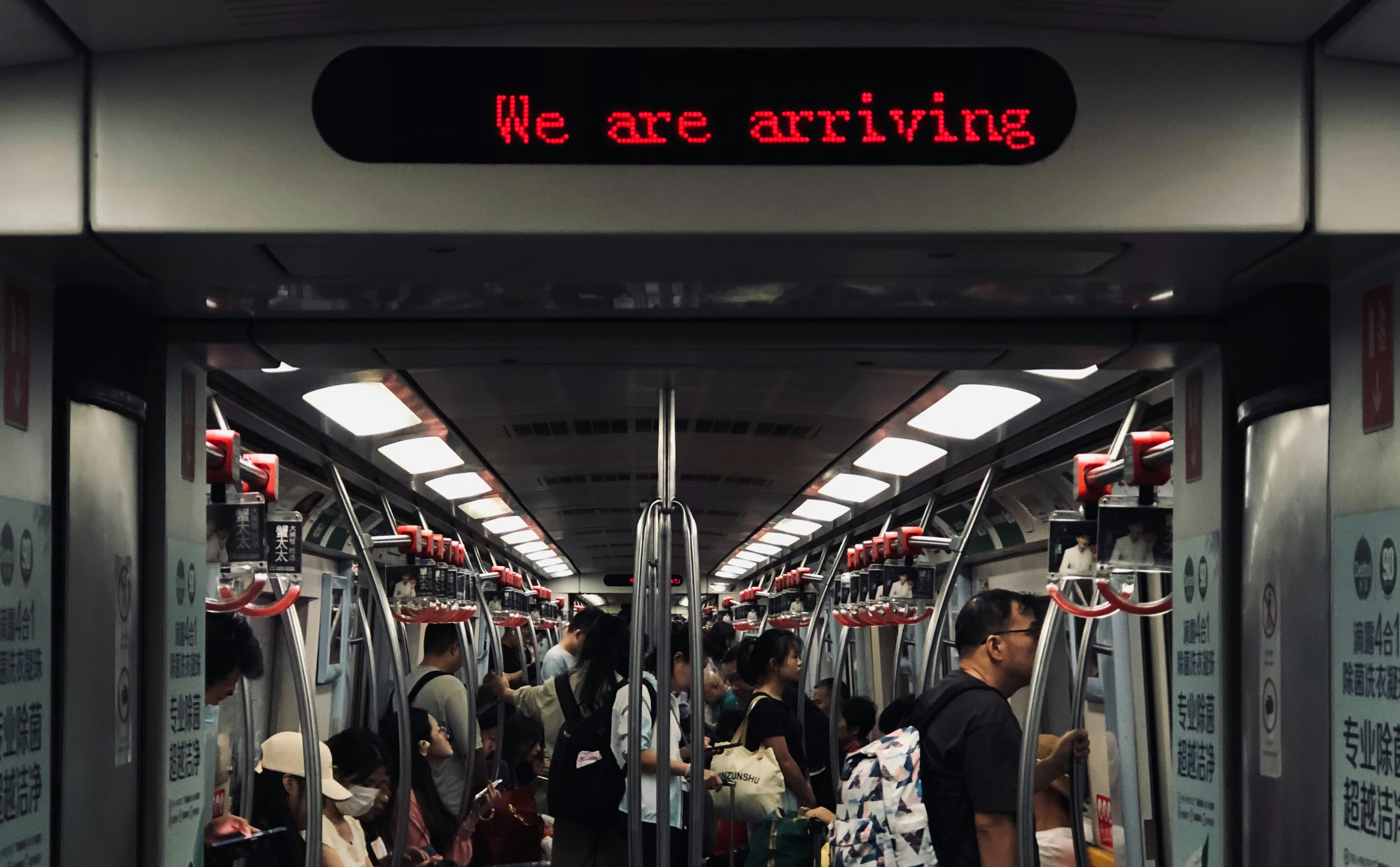 A group of people standing on a subway train